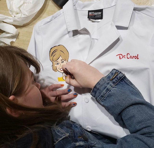 Olivia drawing on coat